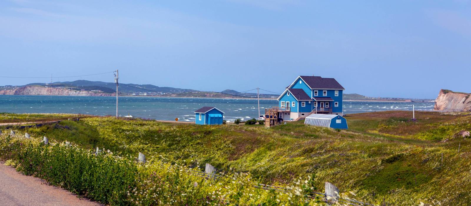 Pass by colourful houses while hiking the archipelago | André Quenneville